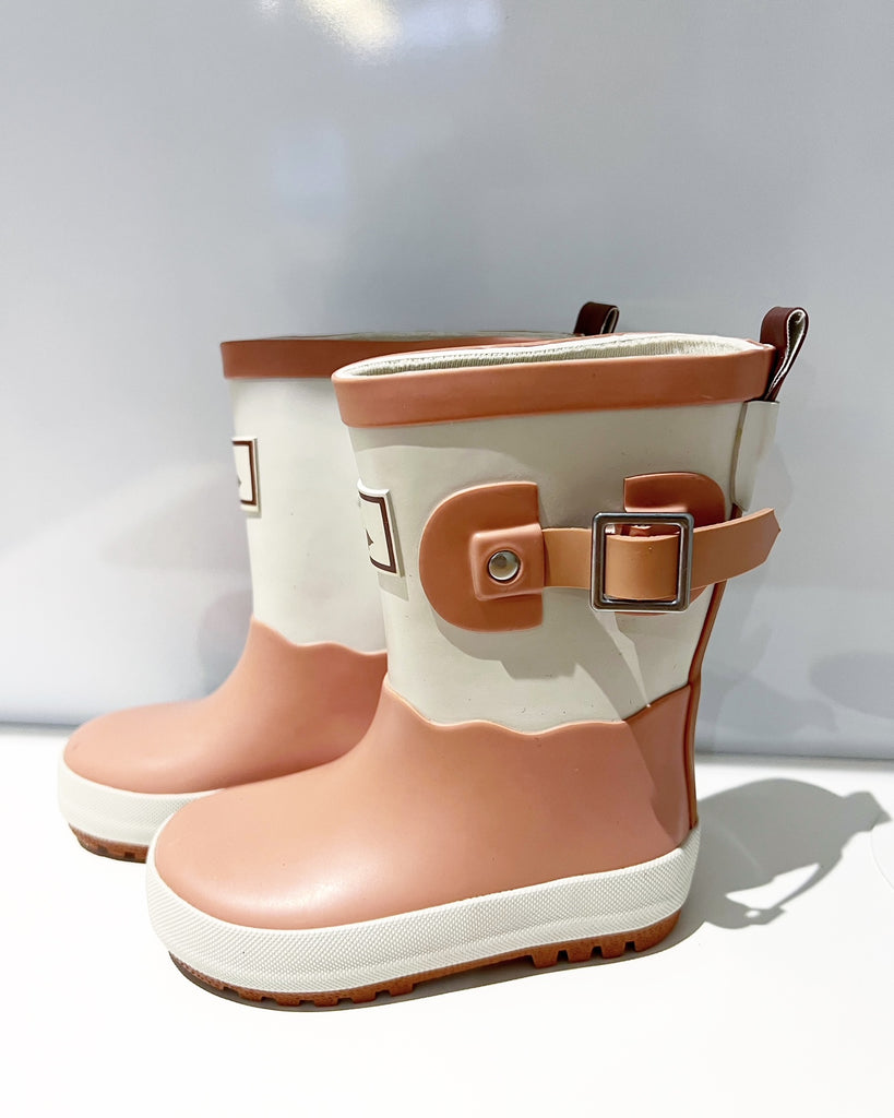 Pink scalloped kid's waterproof wellies from Goose and Gander with a metal buckle on the side.