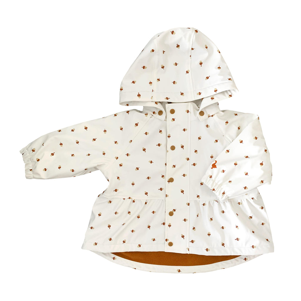 Acorns printed on a toddler’s white waterproof rain jacket. 