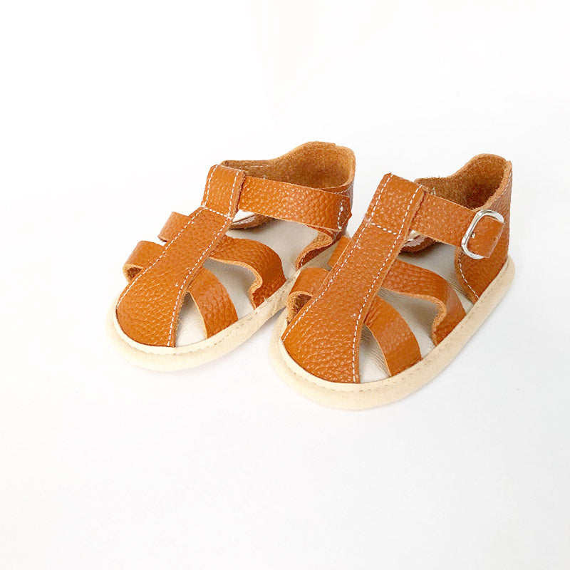 Beach holiday or back-garden totter, let little feet get some air with this perfect pair.