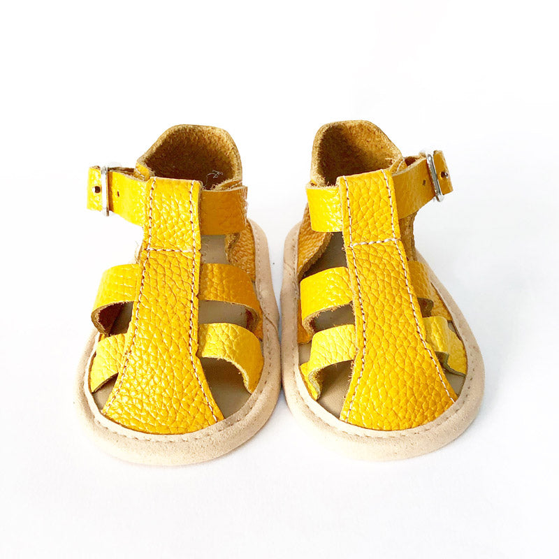 Beach holiday or back-garden totter, let little feet get some air with this perfect pair.